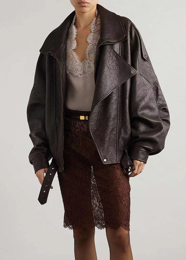 Side view showing drop shoulders and belted hem of a leather bomber jacket