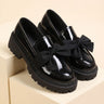 Patent loafer with grosgrain bow and chunky lug sole, front three-quarter view