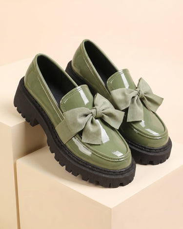 Patent loafer paired with tailored trousers, front view