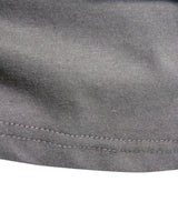 Folded long sleeve crew neck top showing the plain fabric and stitching