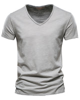 Close-up of the stitched hem on the plain T-shirt