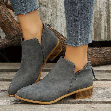 Close-up of pointed toe and V-cut ankle opening on suede boots