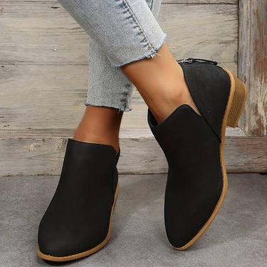 Ankle boots styled with straight-leg trousers, front three-quarter view