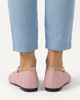 Ballet flat worn on foot, showing pointed toe and strap