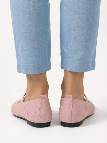 Ballet flat worn on foot, showing pointed toe and strap