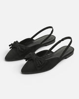 Side view of slingback flat showing adjustable back strap and flat sole