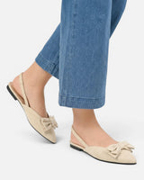 Close-up of structured bow detail on the vamp of the slingback flat