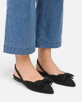 Overhead view of slingback ballet flat showing pointed toe and bow