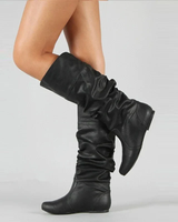Close-up of leather upper and stitching detail on mid-calf pull-on boots