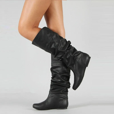 Close-up of leather upper and stitching detail on mid-calf pull-on boots