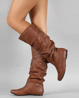 Women's mid-calf leather pull-on boots with flat sole and clean stitching, side view