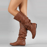 Women's mid-calf leather pull-on boots with flat sole and clean stitching, side view