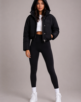 Side profile of the cropped quilted jacket showing waist-length hem and sleeve detail