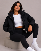 Model wearing the cropped quilted puffer jacket over straight-leg trousers