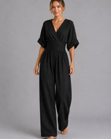 Detail shot of the V-neckline on the denim jumpsuit