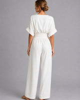 Full-length view of the denim jumpsuit showing the wide-leg trousers