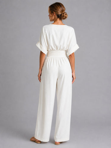 Full-length view of the denim jumpsuit showing the wide-leg trousers