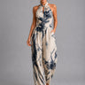 Front view of a wide-leg halter jumpsuit in light blue with an all-over print