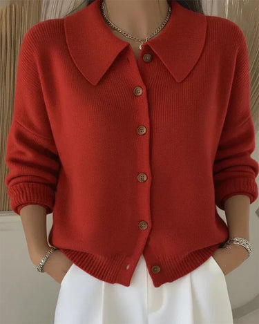 Close-up of warm-toned buttons and ribbed cuffs on knit cardigan