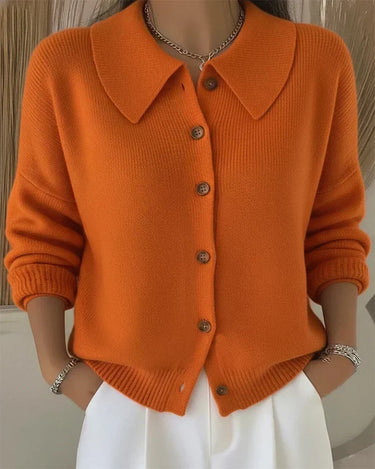 Hip-length knit cardigan with wide collar worn over casual outfit