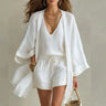 Front view of a three-piece linen co-ord set with V-neck top and drawstring shorts