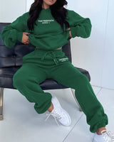 Flat lay of the two-piece jogging set in purple, displaying both top and trousers