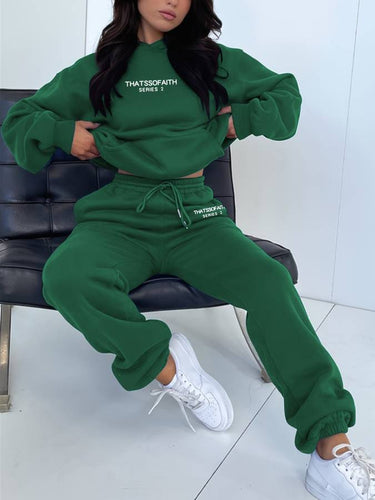 Flat lay of the two-piece jogging set in purple, displaying both top and trousers