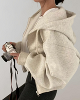 Side view showing the ribbed cuffs and relaxed silhouette of the zip sweatshirt