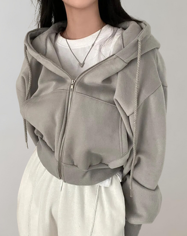 Back view of the hooded sweatshirt showing the ribbed hem and overall fit