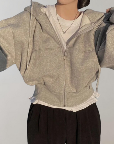Lifestyle shot of the women's zip hoodie worn in a casual setting