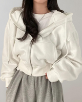 Front view of a relaxed-fit women's hooded zip sweatshirt with drawstring hood