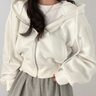 Front view of a relaxed-fit women's hooded zip sweatshirt with drawstring hood