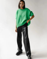 Flat lay of an oversized long-sleeve sweater in dark brown