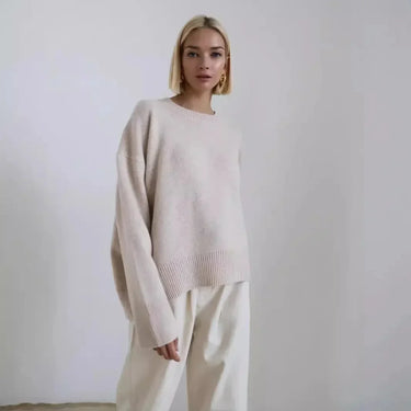 Side view of a relaxed-fit long-sleeve sweater showing hip-length hem