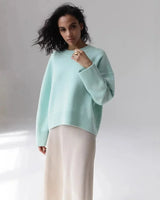 Back view of an oversized round neck sweater in black