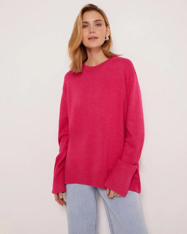 Model wearing a relaxed round neck sweater in light blue, styled casually
