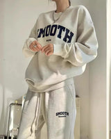 Close-up of the sweatshirt neckline and sleeve detail of the grey co-ord set