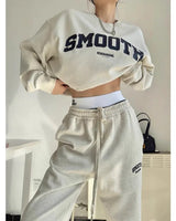 Front view of a grey oversized sweatshirt and jogger co-ord set worn by a model