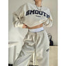 Front view of a grey oversized sweatshirt and jogger co-ord set worn by a model