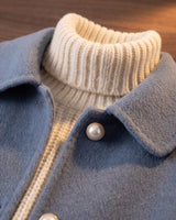 Detail shot of hip-level patch pocket on a wool jacket