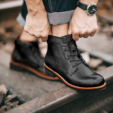 Front view of men's full-grain leather boot showing round toe and lace-up detail
