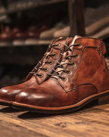 Close-up of dual zip and lace-up closure on men's leather boot