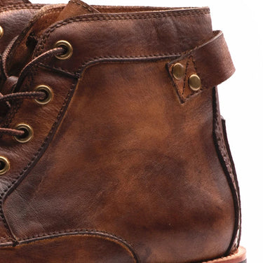 Pair of retro men's leather boots shown side by side on neutral background