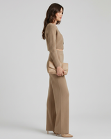 Close-up of the asymmetric layered detail on the knit top