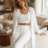 Front view of three-piece ribbed knit co ord set with wide-leg trousers