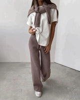 Full-length view of model wearing ribbed knit turtleneck and drawstring trousers