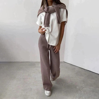 Full-length view of model wearing ribbed knit turtleneck and drawstring trousers