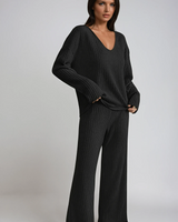 Front view of a ribbed knit two-piece set with V-neckline and wide-leg trousers