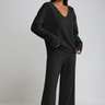 Front view of a ribbed knit two-piece set with V-neckline and wide-leg trousers