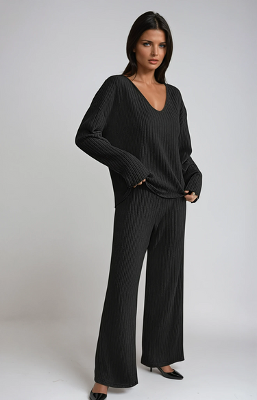 Front view of a ribbed knit two-piece set with V-neckline and wide-leg trousers